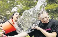  ?? Elise Amendola Associated Press ?? BERYL LIPTON douses Matt Lee during an Ice Bucket Challenge in Boston’s Copley Square this month. The challenge benefits the ALS Assn.