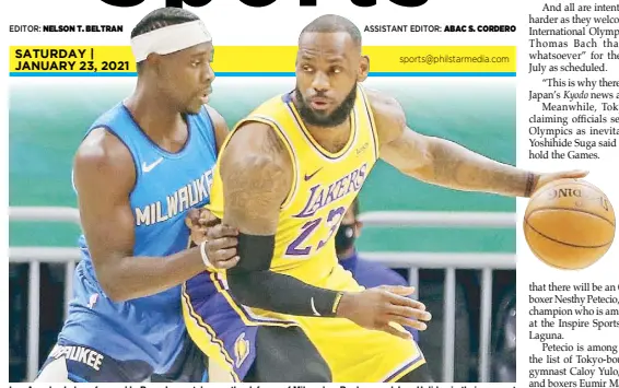  ?? REUTERS ?? Los Angeles Lakers forward LeBron James takes on the defense of Milwaukee Bucks guard Jrue Holiday in their game at the Bradley Center.