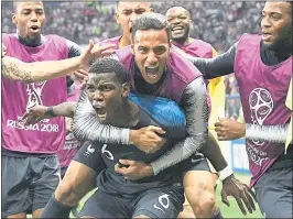  ?? MARTIN MEISSNER — THE ASSOCIATED PRESS ?? France’s Paul Pogba hoists a teammate on his back, celebratin­g after scoring his side’s third goal during the final match of the World Cup against Croatia on Sunday in Moscow.