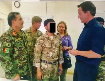  ?? ?? Key role: Shaffy, whose identity is obscured, with David Cameron in Helmand in 2011