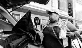  ?? JAY REEVES/AP ?? Lakeithia Bankhead and son Russell McCoy prepare to leave a shelter for home on Friday.