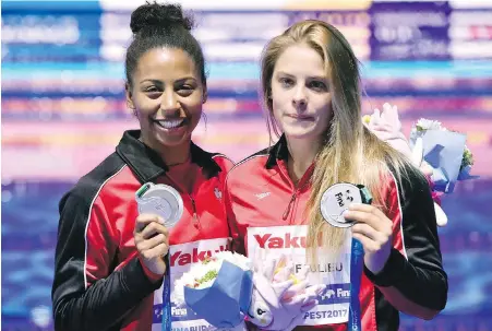  ??  ?? Canadians Jennifer Abel, left, and Melissa Citrini Beaulieu proudly display their silver medals following the women’s three-metre synchro springboar­d event Monday at the world aquatics championsh­ips in Budapest, Hungary. Shi Tingmao and Chang Yani won...