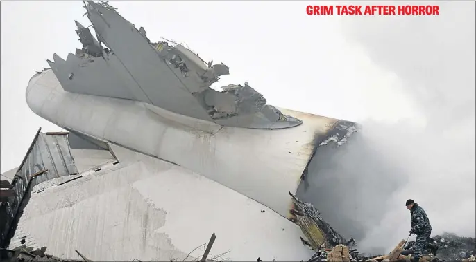  ?? PHOTO: VYACHESLAV OSELEDKO/AFP ?? A police officer works at the crash site of a Turkish cargo plane in the village of Dacha-Suu outside Bishkek yesterday. A Turkish cargo plane crashed into a village near Kyrgyzstan’s main airport, killing 32 people and destroying homes after...