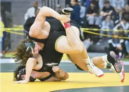  ?? CLOE POISSON/SPECIAL TO THE COURANT ?? Norwalk’s Brendan Gilchrist flips East Hartford’s Sam Montovani during the final match of the 195-pound weight class at the State Open Wrestling Tournament at the Floyd Little Athletic Center last year.