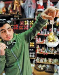  ?? Reuters ?? A Palestinia­n vendor displays a Christmas gift in a shop in Bethlehem in the occupied West Bank on Wednesday.