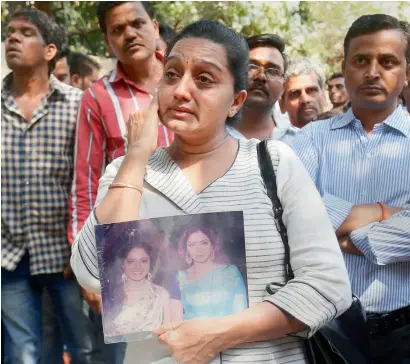  ?? PTI ?? Sridevi fans wait outside her residence at Lokhandwal­a Complex, in Andheri, north-west, Mumbai on Sunday. —