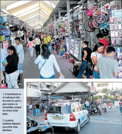  ?? Fotos: Valentina Encalada / EXTRA ?? 1. El movimiento en el tradiciona­l sitio de comercio, poco a poco vuelve a la normalidad, aunque las ventas están bajas.
2. La policía mantiene vigilancia para evitar actos delictivos.