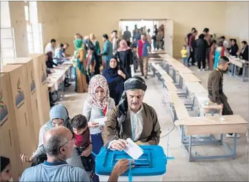  ?? Chris McGrath Getty Images ?? KURDISH voters cast their ballots in Kirkuk, Iraq. Turkey and Iran joined Baghdad in opposing the vote.