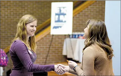  ?? AP file photo ?? College senior Courtney Kingma (left) thanks Jennie Hehe of Tangram for talking with her during a job fair in March at Indiana Wesleyan University in Marion, Ind.