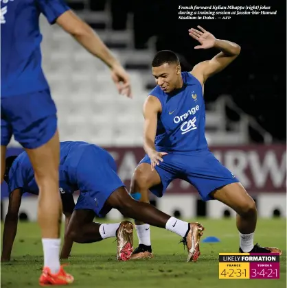  ?? ?? French forward Kylian Mbappe (right) jokes during a training session at Jassim-bin-hamad Stadium in Doha . — afp