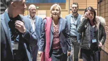  ?? — AFP ?? Marine Le Pen (C) arrives to attend a two-day political rally to kick off her presidenti­al campaign on Saturday in Lyon.