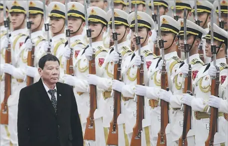  ?? How Hwee Young European Pressphoto Agency ?? PHILIPPINE PRESIDENT Rodrigo Duterte reviews an honor guard in Beijing. He said that “America has lost now” and suggested that he was also eager to cozy up to Russian President Vladimir Putin. “Maybe I will also go to Russia to talk to Putin,” he said.