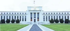  ?? GETTY IMAGES ?? The Federal Reserve on Wednesday held its key interest rate near zero and vowed to maintain its bond-buying stimulus.