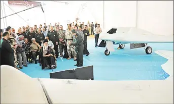  ??  ?? A handout picture released by the office of Iran’s Supreme Leader Ayatollah Ali Khamenei on May 11, shows him (center left), sitting next to the captured US RQ-170 sentinel high-altitude reconnaiss­ance that crashed in Iran in December 2011 and its...