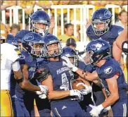  ?? MARC PENDLETON / STAFF ?? Fairmont’s Trey Baker (with ball) is congratula­ted by teammates after a first-half intercepti­on Thursday against Alter. The Firebirds won 12-6.