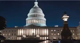  ?? J. SCOTT APPLEWHITE/AP ?? The Capitol is seen at dusk Friday as work in the Senate continues on the Democrats’ $1.9 trillion COVID-19 relief bill.