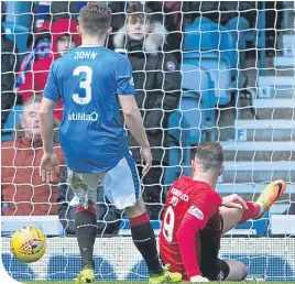  ??  ?? Kris Boyd scores the game’s only goal with Declan John looking on