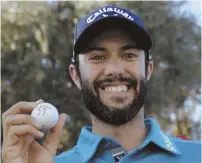  ?? AP PHOTO ?? MARK IT DOWN: Adam Hadwin poses with a commemorat­ive ball after shooting a 59 to take the lead in the CareerBuil­der Challenge yesterday.