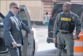  ?? AP/STEVE RUARK ?? Officer Garrett Miller (left), one of six members of the Baltimore Police Department who were charged in the death of Freddie Gray, arrives for court Wednesday, where he heard all charges had been dropped.