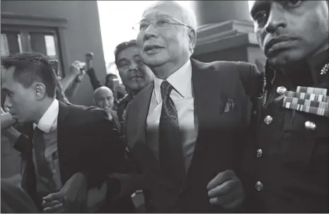  ?? Photo: VCG ?? Former Malaysian prime minister Najib Razak (C) arrives for a court appearance at the Duta court complex in Kuala Lumpur on Wednesday.
