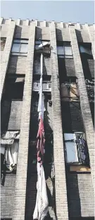  ?? Pictures: Tracy Lee Stark ?? BURNT OUT. A firefighte­r cools down a section of Cape York building in Hillbrow yesterday. Some residents tied sheets together in a desperate bid to escape from the burning building.