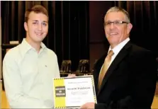  ??  ?? Prairie Grove High Principal Ron Bond recognizes Will Pohlman, a 2013 graduate of Prairie Grove High, as the high school’s first National AP (Advanced Placement) Scholar. To receive the award, a student has to score an average 4.0 on all AP exams and...