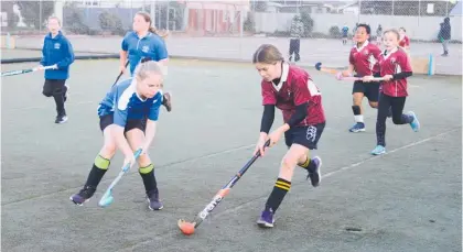  ??  ?? Huia Range’s Kath Smith tries to get around Ruahine’s Grace Morgans in the Kiwi Sticks match