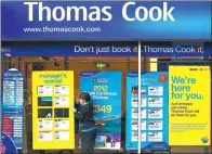  ?? PROVIDED TO CHINA DAILY ?? A worker changes the window display of Thomas Cook in Loughborou­gh, central England.