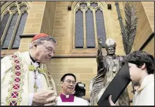  ??  ?? George Pell liest 2011 bei einer Segnung im australisc­hen Sydney aus der Bibel.