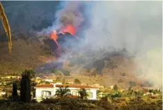  ?? The Associated Press ?? ■ Lava flows from an eruption of a volcano at the island of La Palma in the Canaries, Spain, on Sunday. The volcano on the Atlantic Ocean island erupted after a weeklong buildup of seismic activity, prompting authoritie­s to evacuate thousands as lava flows destroyed isolated houses and threatened to reach the coast. New eruptions continued into the night.