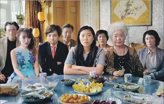  ?? Sundance Institute ?? AWKWAFINA, center, drew on her relationsh­ip with her own grandmothe­r to play the fictional stand-in for writer-director Lulu Wang in “The Farewell.”