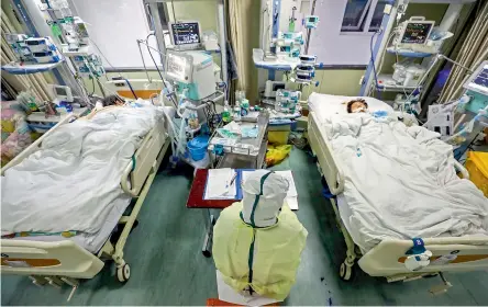  ?? — AP ?? A medical worker monitors patients in the isolated intensive care unit at a hospital in Wuhan of central China’s Hubei province.