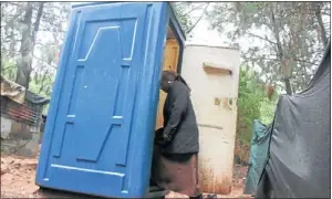  ?? PHOTO: BAFANA MAHLANGU ?? OPEN DOOR: A woman enters one of two toilets used by the Kosmos informal settlement near Hartbeespo­ort Dam