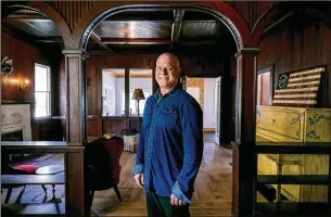  ?? PHOTOS BY RICHARD GRAULICH / THE PALM BEACH POST ?? Ernie Fidanza stands inside the historic 1924 Eli Sims house in Jupiter. Fidanza bought the house three years ago for $80,000 to save it from developers.