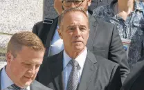  ?? Timothy A. Clary / Getty Images ?? U.S. Rep. Chris Collins, R-N.Y., leaves federal court in New York on Wednesday after being indicted on insider trading.