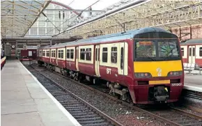  ?? ?? Unrefurbis­hed Class 320/3 No. 320307 awaits its next turn at Helensburg­h Central on March 16, 2006. It carries the revised version of SPT carmine and cream livery.