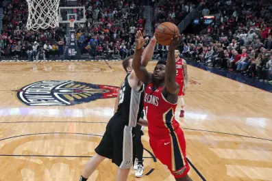  ?? AP ?? New Orleans Pelicans forward Zion Williamson (right) goes to the basket against San Antonio Spurs centre Jakob Poeltl in the second half of their NBA game in New Orleans, Louisiana, on Wednesday.