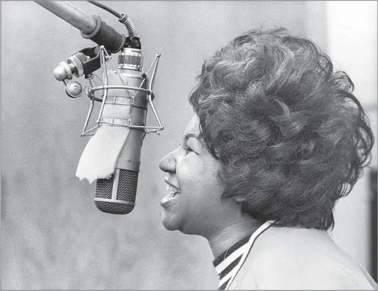  ?? Michael Ochs Archives / Getty Images ?? “AND YOU PUT THE LOAD RIGHT ON ME” Aretha Franklin records the Band’s song “The Weight” in the Atlantic Records studio on Jan. 9, 1969, in New York City. In her career, she recorded many other artists’ songs, including Otis Redding’s “Respect” and Paul Simon’s “Bridge Over Troubled Water.”