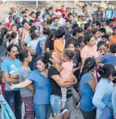  ?? VERONICA G. CARDENAS/AP 2019 ?? Migrants crowd together looking to get a meal in an encampment near the Gateway Internatio­nal Bridge in Matamoros, Mexico.