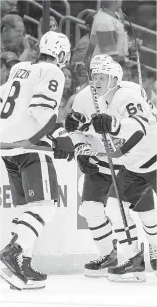  ?? CHRIS O’MEARA/AP ?? Maple Leafs center David Kampf, right, celebrates his goal against the Lightning with defenseman Jake Muzzin, left, during the second period in Game 3.