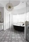  ??  ?? 4. Add visual interest: This bathroom features interestin­g floor tile and a dramatic bathtub in a bay window.