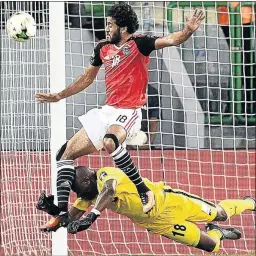  ?? PHOTO: JUSTIN TALLIS/AFP ?? Uganda goalkeeper Denis Onyango, bottom, blocks a shot on goal by Egypt’s forward Marwan Mohsen on Saturday.