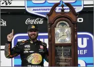  ?? STEVE HELBER — THE ASSOCIATED PRESS ?? Martin Truex Jr. celebrates after winning the Monster Energy Cup race on April 11at Martinsvil­le Speedway,