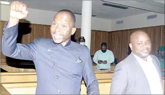  ?? (File pic) ?? Arrested Members of Parliament, Mduduzi Bacede Mabuza of Hosea (L) and Mthandeni Dube of Ngwempisi having a moment in court.