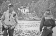  ??  ?? Police officers guard the waterfront point as M/S Thorbjorn ferry brings activists from the Norwegian Labour Party Youth division ( AUF ) to the Utoya island some 40 km west of Oslo where they hold their first summer camp session since the 2011...