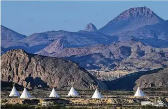  ?? Josie Norris photos / Staff photograph­er ?? The sun sets on the Basecamp Terlingua tipis, with the Chisos Mountains in the background. The tipis are owned by Jeff Leach, who has built a handful of rentals around Terlingua.