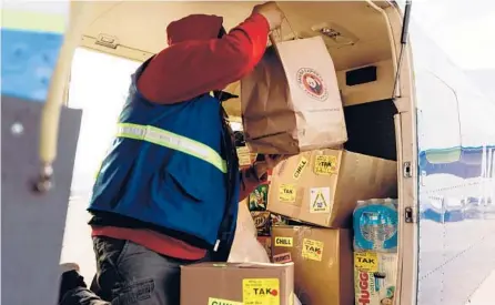  ?? KERRY TASKER/THE NEW YORK TIMES ?? A fast-food takeout order sits on a plane with other cargo April 21 at Merrill Field in Anchorage, Alaska.