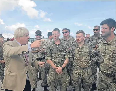  ?? Picture: PA. ?? Foreign Secretary Boris Johnson talks to Royal Marines after stopping in Barbados.