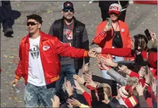  ?? TRAVIS HEYING — THE WICHITA EAGLE/TNS ?? Chiefs quarterbac­k Patrick Mahomes greets fans as the team's Super Bowl Parade makes its way through downtown Kansas City on Wednesday.