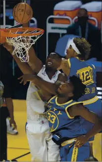  ??  ?? The Clippers’ Serge Ibaka, left, shoots over the Warriors’ James Wiseman, middle, and Kelly Oubre Jr. on Wednesday in a 108-101victory by L.A.